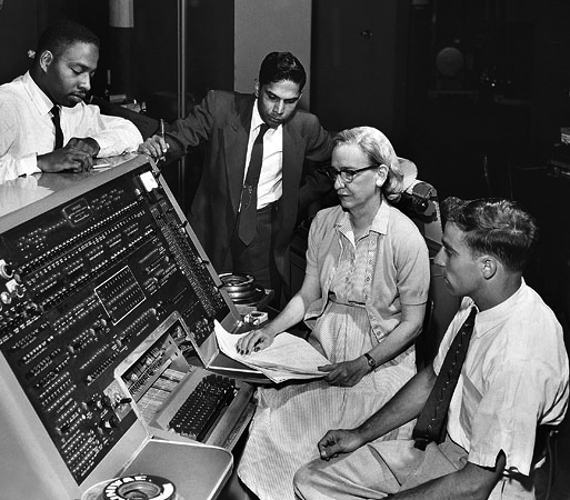 Grace Hopper, an American mathematician and rear admiral in the U.S. Navy who was a pioneer in developing computer technology, at the helm of the UNIVAC keyboard. Courtesy of Wikimedia Commons